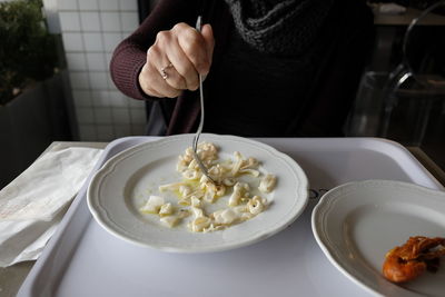 Close-up of hand holding food with fork