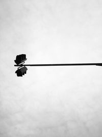 Low angle view of overhead cable car against sky