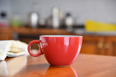 Close-up of coffee cup on table at home