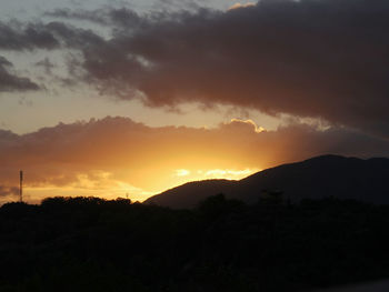 Silhouette landscape against scenic sky