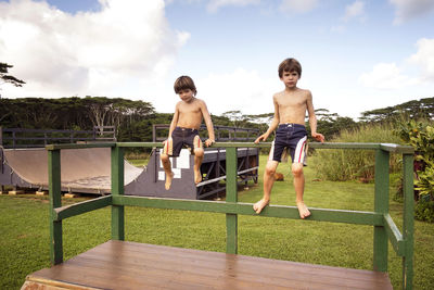 Boys sitting on railing