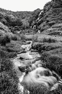 Scenic view of waterfall against sky