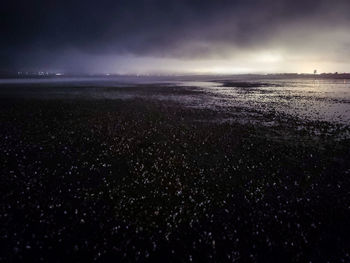 Scenic view of sea against sky at night