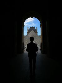 Silhouette man in historic building against sky