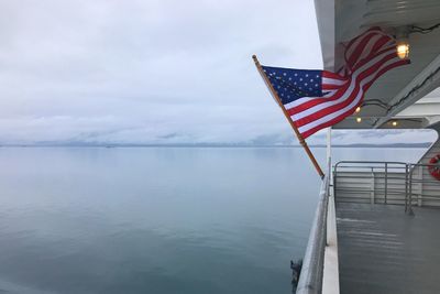 Flag on nautical vessel against sky