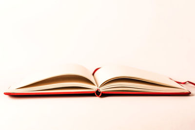 Close-up of books on table against white background