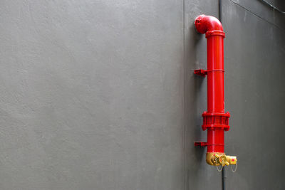 Close-up of red pipe on wall