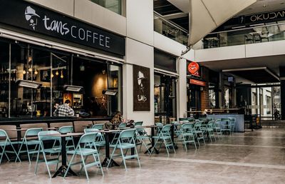 Empty chairs and tables in cafe at restaurant