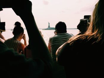 Tourists photographing statue of liberty