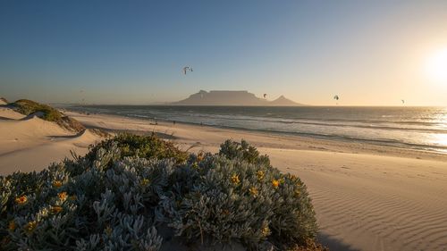 Scenic view of sea against clear sky during sunset