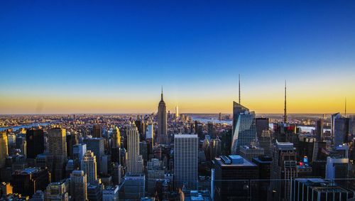 High angle shot of cityscape against blue sky