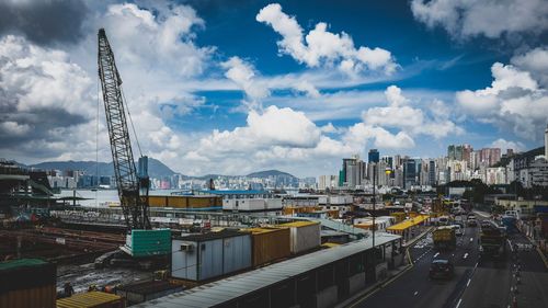 View of cityscape against cloudy sky