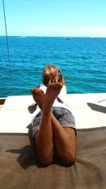 Young woman relaxing in boat on sea