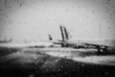 Close-up of wet airplane window in rainy season