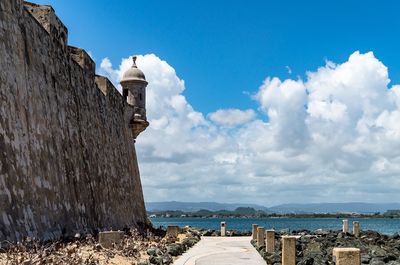 Panoramic view of old building by sea against sky