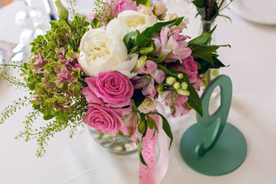 Wedding table setting with green candle and flowers