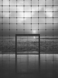 Digital composite image of wall and sea against sky