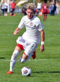 Full length of man playing soccer on field