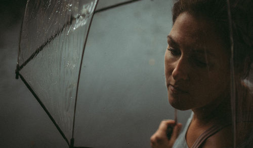 Close-up portrait of young man looking through window