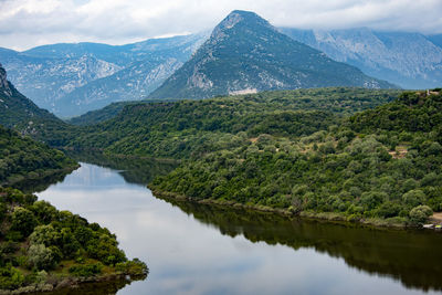 Scenic view of lake and mountains against sky