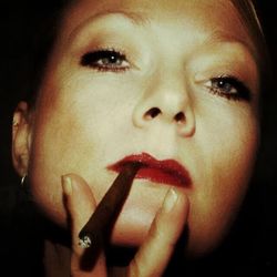 Close-up portrait of young woman smoking