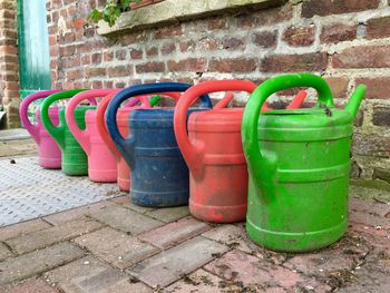 Multi colored containers against wall