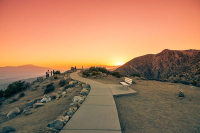 Scenic view of mountains against orange sky