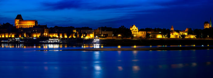 Reflection of illuminated buildings in water at night