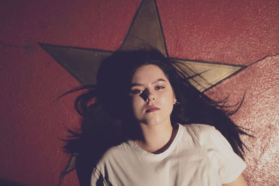 Portrait of young woman lying on floor