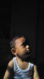 Portrait of boy looking away against wall