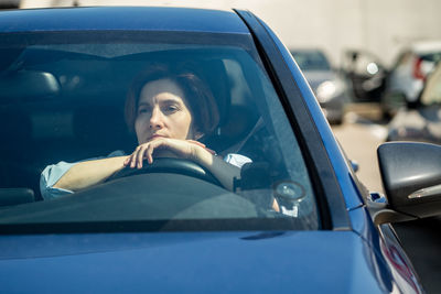 Portrait of young woman in car