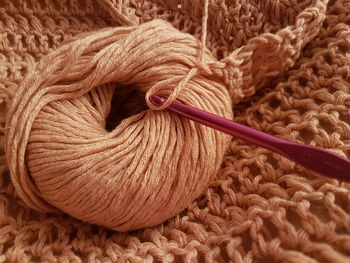 High angle view of wool with knitting needle