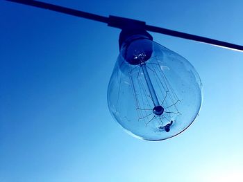 Low angle view of lamp against blue sky