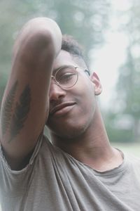 Portrait of young man showing tattoo on hand