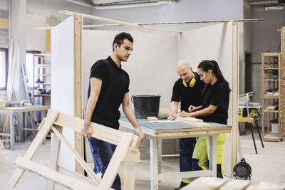 Carpentry students and teacher working at class