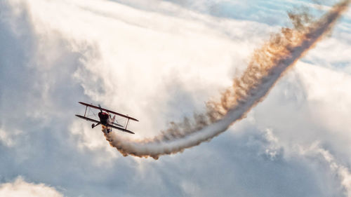 Low angle view of airplane flying against sky