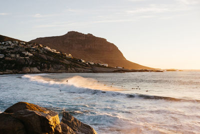 Scenic view of sea and mountains against sky