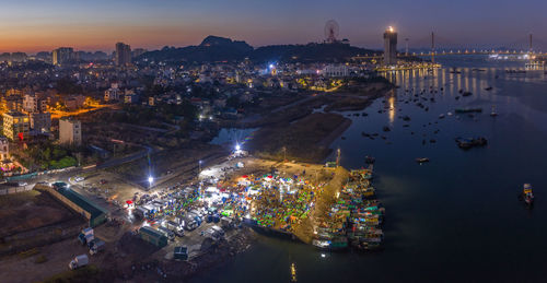 High angle view of illuminated city buildings at night