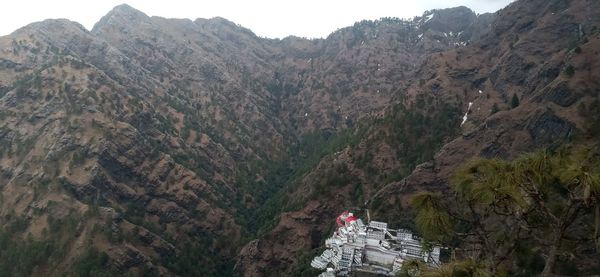 Panoramic view of people on rock by mountains