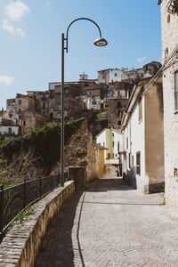Street amidst buildings against sky