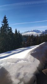 Scenic view of snowcapped mountains against blue sky