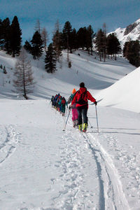 People skiing on snow covered field