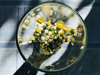 Close-up of flowers in glass vase on table