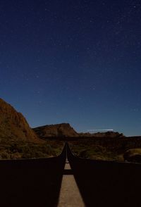 Scenic view of mountains against clear sky at night