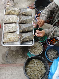 High angle view of man holding fish at market