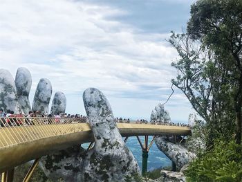 View of bridge over river against cloudy sky