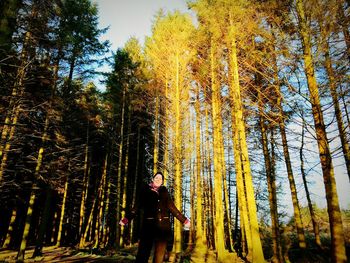 Man standing on tree trunk