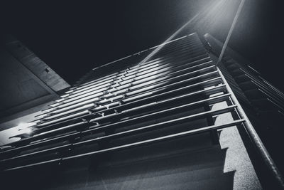 Low angle view of illuminated building against sky at night