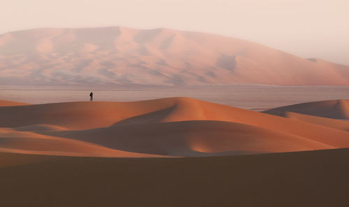 Scenic view of desert against sky during sunset