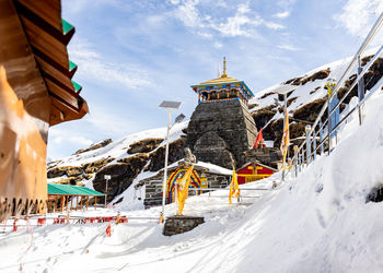 Isolated ancient holy hindu temple in himalayan mountain range with bright blue sky